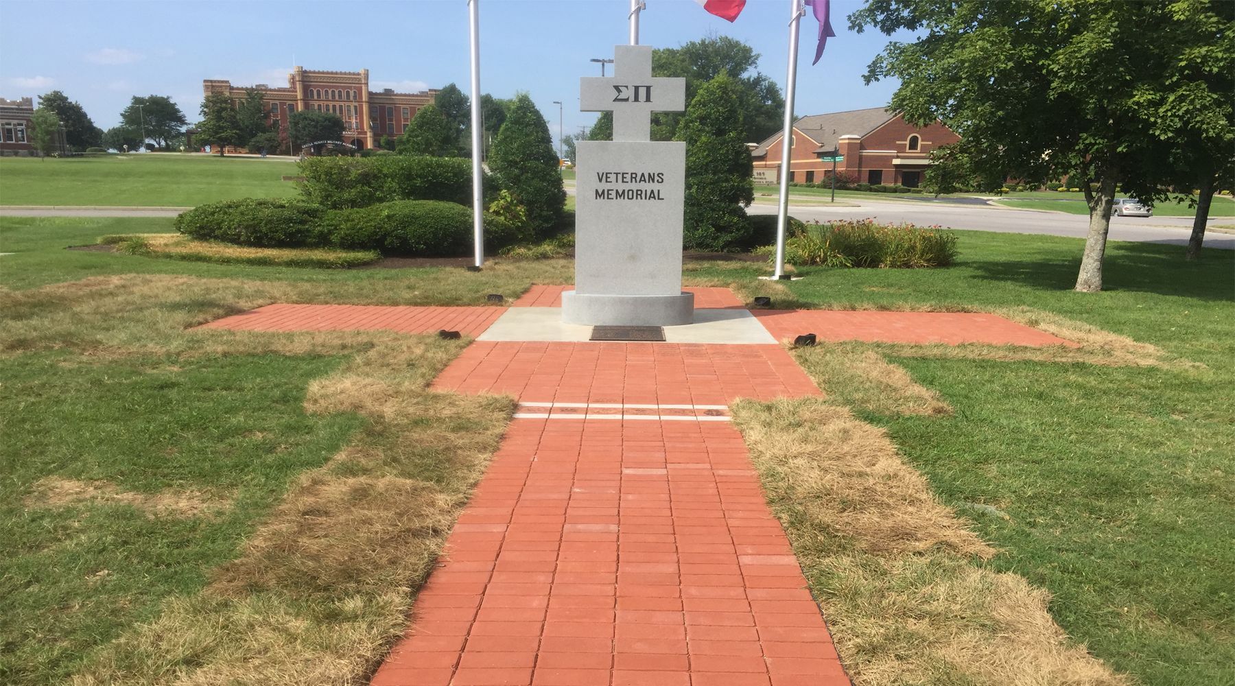 Picture of a red brick path leading to a sigma pi veterans memorial.