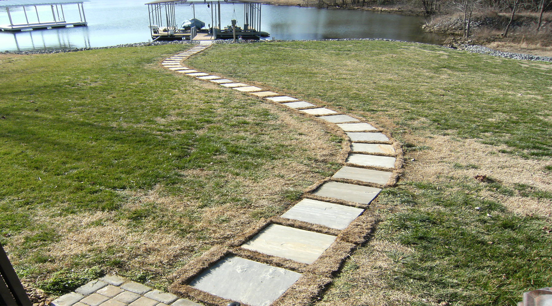 Picture of a stone pathway with the lake in the background.