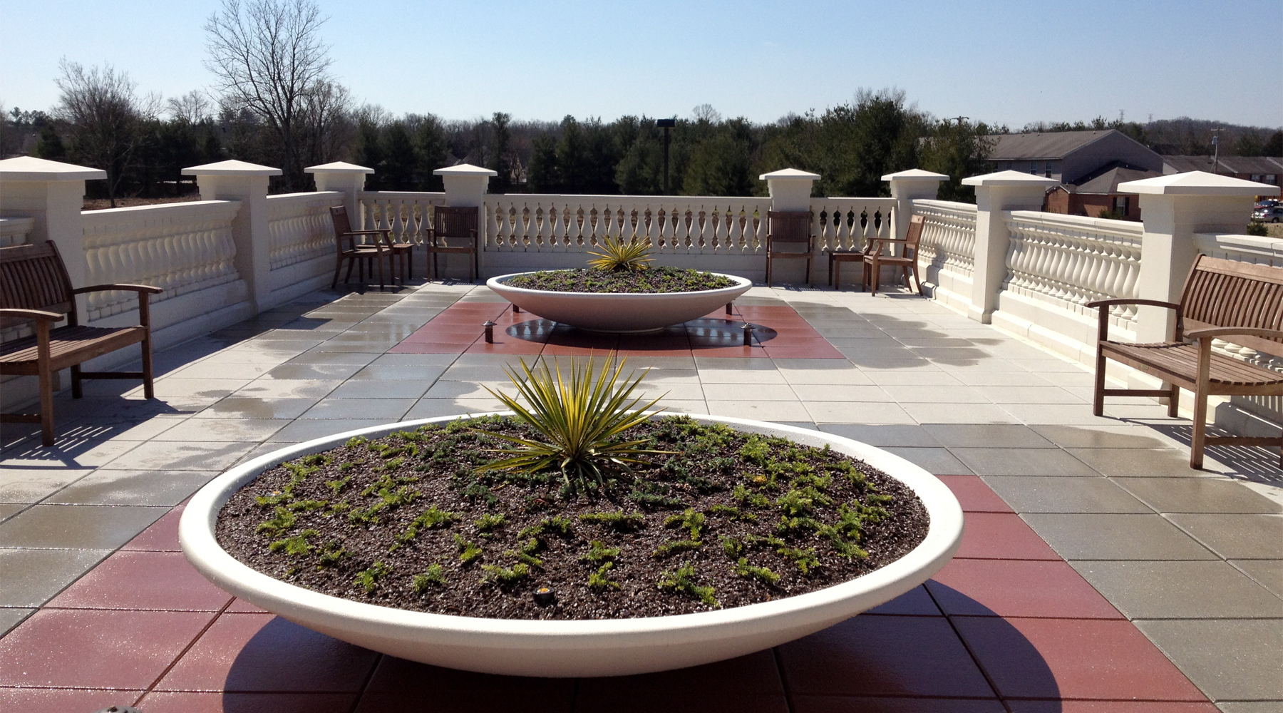 Picture of a concrete planter on a rooftop mezzanine.